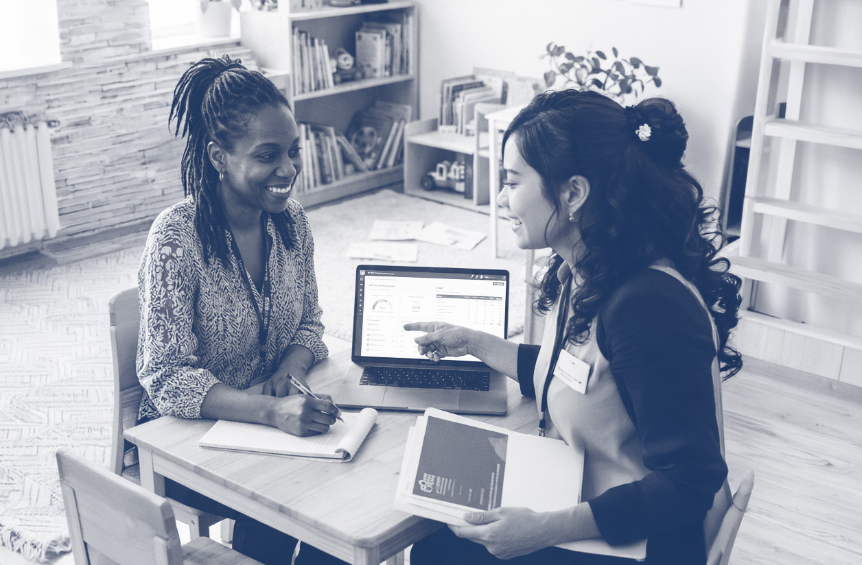 Child care provider sitting with a business coach.