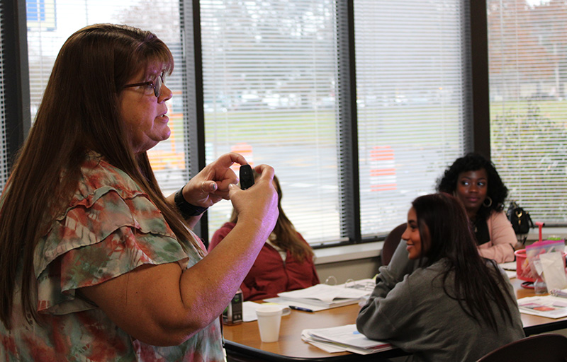 Safety Training presentation within a small board room by one of Professional Development staff.